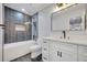 Stylish bathroom with modern vanity, bathtub, and sleek gray tile and mosaic accent wall at 615 Nw Mark Trail Nw Ct, Atlanta, GA 30328