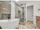 Modern bathroom featuring a soaking tub, glass-enclosed shower, and elegant finishes at 615 Nw Mark Trail Nw Ct, Atlanta, GA 30328