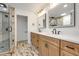 Bathroom featuring double vanity with modern countertop and cabinets, with separate glass shower stall at 615 Nw Mark Trail Nw Ct, Atlanta, GA 30328