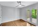 Bright bedroom features hardwood floors, ceiling fan, and double doors to a private deck at 615 Nw Mark Trail Nw Ct, Atlanta, GA 30328