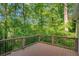 Wooden deck overlooks a lush, green landscape, providing a serene outdoor space at 615 Nw Mark Trail Nw Ct, Atlanta, GA 30328