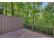 Inviting deck with black metal railing offers a peaceful view of the surrounding lush greenery at 615 Nw Mark Trail Nw Ct, Atlanta, GA 30328