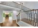 Foyer featuring modern metal and wood staircase and view into the living room with fireplace at 615 Nw Mark Trail Nw Ct, Atlanta, GA 30328