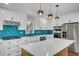 Open kitchen with white cabinets, quartz countertops, kitchen island, and stainless steel appliances at 615 Nw Mark Trail Nw Ct, Atlanta, GA 30328