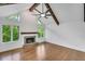 Bright living room with hardwood floors, stone fireplace, vaulted ceilings, wood beam and lots of natural light at 615 Nw Mark Trail Nw Ct, Atlanta, GA 30328