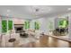 Bright living room features a fireplace, recessed lighting and hardwood floors, flowing to the dining area at 615 Nw Mark Trail Nw Ct, Atlanta, GA 30328