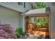Inviting covered porch with wood deck, stone walkway, and view of lush landscaping at 615 Nw Mark Trail Nw Ct, Atlanta, GA 30328