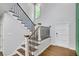 Modern staircase with metal railings and wood steps, leading to upper level at 615 Nw Mark Trail Nw Ct, Atlanta, GA 30328