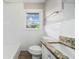 Bright bathroom features a tiled wall, toilet, tub and shower, granite countertop, and window at 2078 Olive Springs Se Rd, Marietta, GA 30060