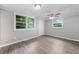 Cozy bedroom with natural light, fresh paint, new floors, and a ceiling fan for comfortable living at 2078 Olive Springs Se Rd, Marietta, GA 30060