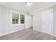 Bedroom with wood-look floors, wainscoting, and a bright view to the exterior at 2078 Olive Springs Se Rd, Marietta, GA 30060