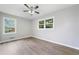 Bright, neutral bedroom with hardwood-style flooring, fan, and windows for natural light at 2078 Olive Springs Se Rd, Marietta, GA 30060