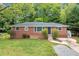 Charming single-story brick home with a well-maintained front yard and mature trees offering curb appeal at 2078 Olive Springs Se Rd, Marietta, GA 30060