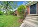 Close-up view of the home's entrance with a dark front door, concrete steps, and well-kept landscaping at 2078 Olive Springs Se Rd, Marietta, GA 30060