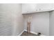 Utility room with brick wall, washer hook-ups, upper cabinets, and wood-look floors at 2078 Olive Springs Se Rd, Marietta, GA 30060