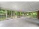 Large screened porch offering ample space and views of the wooded backyard at 2078 Olive Springs Se Rd, Marietta, GA 30060