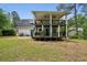 Exterior view of a home featuring a deck and lush backyard with mature trees at 300 Summer Pond Trl, Lawrenceville, GA 30046