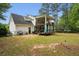 Exterior of a two-story home featuring a spacious deck and lush backyard with mature trees at 300 Summer Pond Trl, Lawrenceville, GA 30046