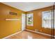 Bedroom with bright yellow walls, hardwood flooring, bright window and closet space at 300 Summer Pond Trl, Lawrenceville, GA 30046