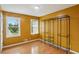 Bedroom with a sunny window and hardwood flooring featuring a black wire shelving unit at 300 Summer Pond Trl, Lawrenceville, GA 30046