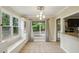 Bright breakfast nook featuring tiled floor, a bay window with bench seating, and view to the backyard deck at 300 Summer Pond Trl, Lawrenceville, GA 30046