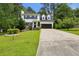 Charming two-story home with a well-manicured lawn and inviting curb appeal surrounded by lush trees at 300 Summer Pond Trl, Lawrenceville, GA 30046
