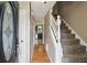 Welcoming home foyer with hardwood floors and a staircase leading to the upper level of the house at 300 Summer Pond Trl, Lawrenceville, GA 30046