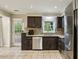 Galley kitchen with stainless steel appliances, granite countertops, tiled backsplash and access to the outdoor deck at 300 Summer Pond Trl, Lawrenceville, GA 30046