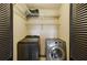 Laundry closet includes washer, dryer, and wire shelving at 300 Summer Pond Trl, Lawrenceville, GA 30046