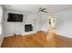 Bright living room featuring hardwood floors, a modern fireplace, and an open layout at 300 Summer Pond Trl, Lawrenceville, GA 30046