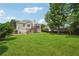 Expansive backyard featuring a lush green lawn, mature trees, and a two-story wooden deck at 3123 Morgan Box Ln, Buford, GA 30519
