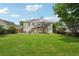 Large backyard with a two story deck, an expansive lawn, and mature trees at 3123 Morgan Box Ln, Buford, GA 30519