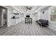 Finished basement with a kitchenette, a table with stools, built-in shelves, and a black couch at 3123 Morgan Box Ln, Buford, GA 30519
