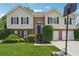 Charming two-story home with brick and siding, arched front door, manicured lawn, and a basketball hoop at 3123 Morgan Box Ln, Buford, GA 30519