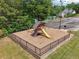 Community playground with a slide and swings nestled in a fenced mulched area with mature trees at 3123 Morgan Box Ln, Buford, GA 30519
