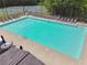 Aerial view of a community pool with lounge seating, umbrellas and tables for residents at 3123 Morgan Box Ln, Buford, GA 30519