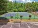 Aerial view of community tennis courts nestled among mature trees, with parking nearby at 3123 Morgan Box Ln, Buford, GA 30519