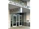 Exterior view of The Plaza Midtown North, with glass doors and prominent signage at 44 Peachtree Nw Pl # 1728, Atlanta, GA 30309