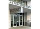 Modern condo building entrance with the building name in large silver lettering at 44 Peachtree Nw Pl # 1728, Atlanta, GA 30309