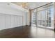 Bright, open room with hardwood floors and large windows with cityscape view at 44 Peachtree Nw Pl # 1728, Atlanta, GA 30309
