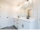 Bathroom with a double sink vanity, modern fixtures, and grey tile flooring at 4523 Moray Dr, Mableton, GA 30126