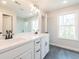 Bathroom with a double sink vanity, modern fixtures, and grey tile flooring at 4523 Moray Dr, Mableton, GA 30126