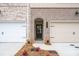 Exterior of townhome with two-car garage, dark trim door and address number at 4523 Moray Dr, Mableton, GA 30126