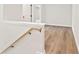 Hallway with hardwood floors, white trim, and staircase with wooden railing at 4523 Moray Dr, Mableton, GA 30126