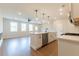 Bright kitchen with an island, stainless steel dishwasher, hardwood floors and open layout to living area at 4523 Moray Dr, Mableton, GA 30126