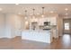 Open concept kitchen featuring an island with pendant lighting, stainless steel appliances, and hardwood floors at 4523 Moray Dr, Mableton, GA 30126