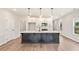 Open kitchen featuring a large island with white countertops, black base cabinets, and pendant lighting at 4523 Moray Dr, Mableton, GA 30126