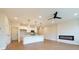 Open floor plan with a kitchen island, electric fireplace, and hardwood floors at 4523 Moray Dr, Mableton, GA 30126