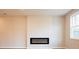 Bright living room featuring an electric fireplace and a large window at 4523 Moray Dr, Mableton, GA 30126