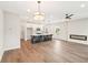 Open-concept living room and kitchen with island, modern light fixture, and fireplace at 4523 Moray Dr, Mableton, GA 30126